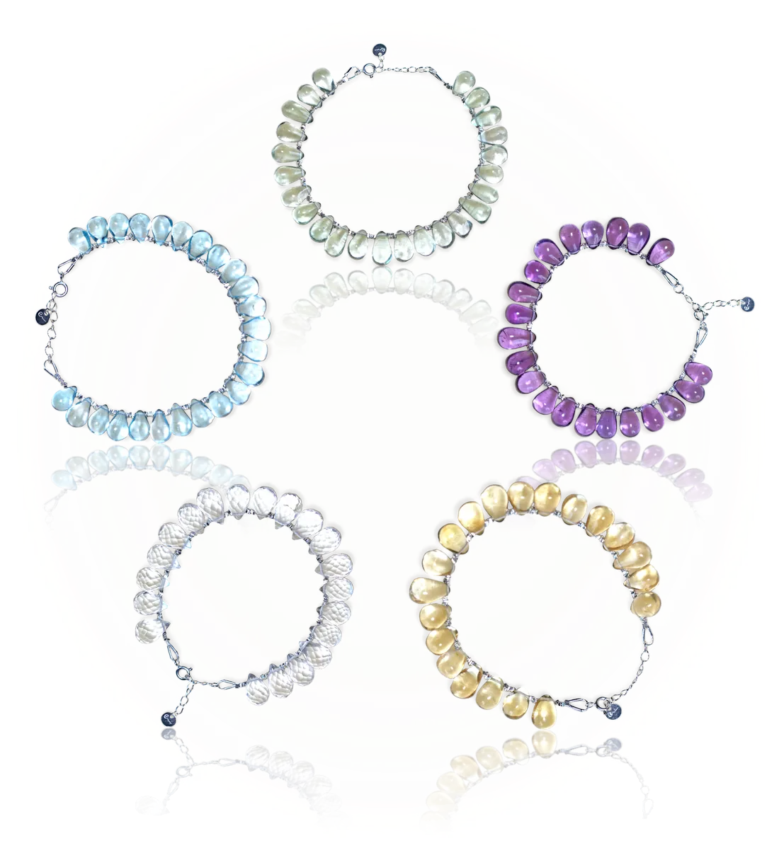 The five elemyra bracelets in a ring, in the generating cycle: pale green Wood, purple Fire, golden Earth, clear faceted Metal and pale blue Water, each on a silver chain with the River E tag