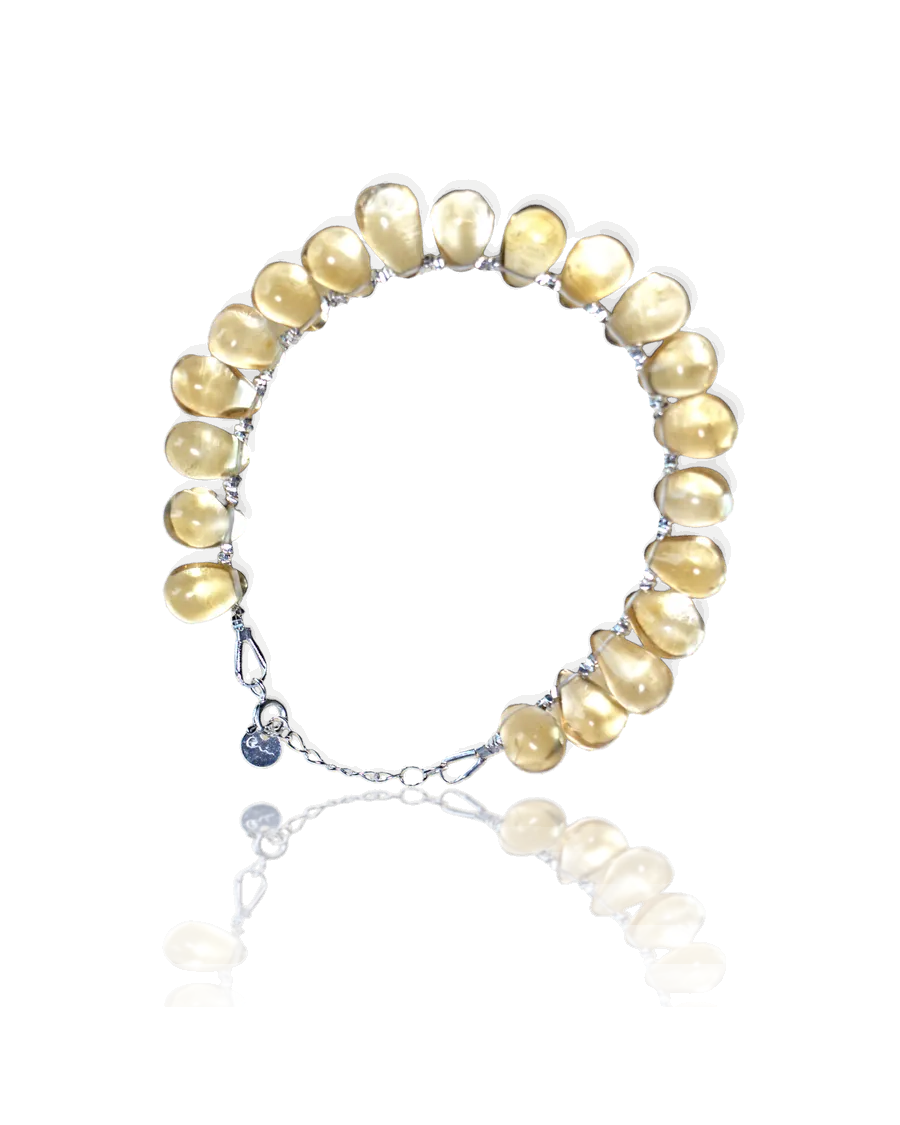 Earth bracelet: golden yellow teardrop stones on a silver chain with a spring-ring clasp and River E tag
