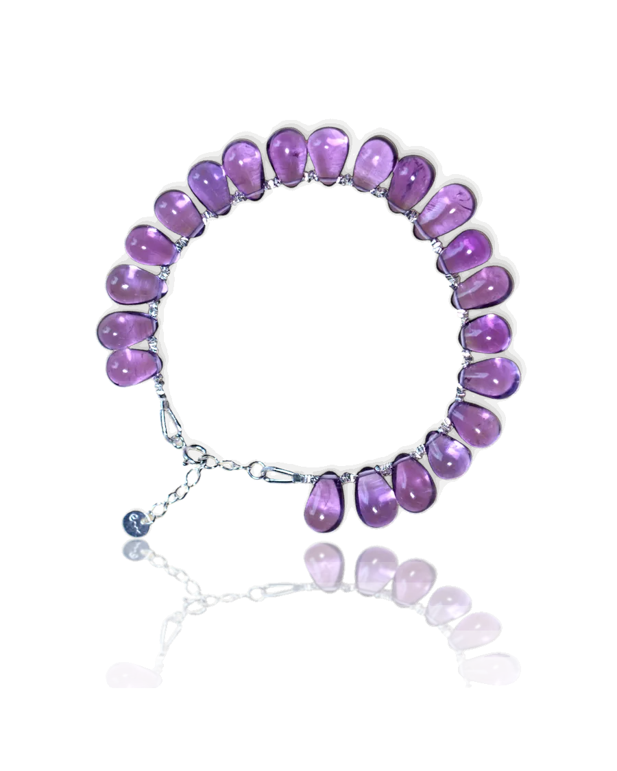 Fire bracelet: purple teardrop stones on a silver chain with a spring-ring clasp and River E tag