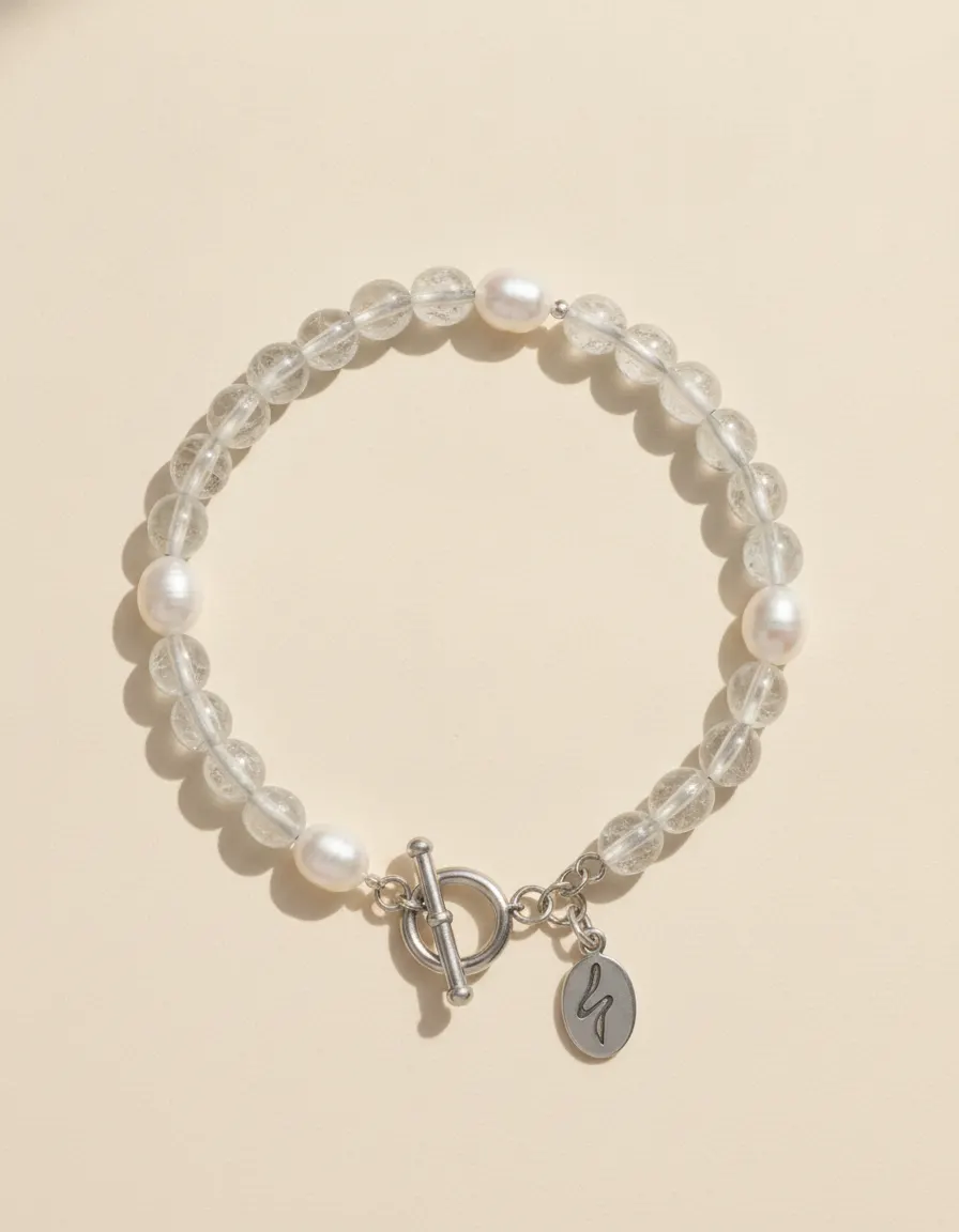 Metal bracelet Meridian, beaded with toggle clasp and River E tag on ivory